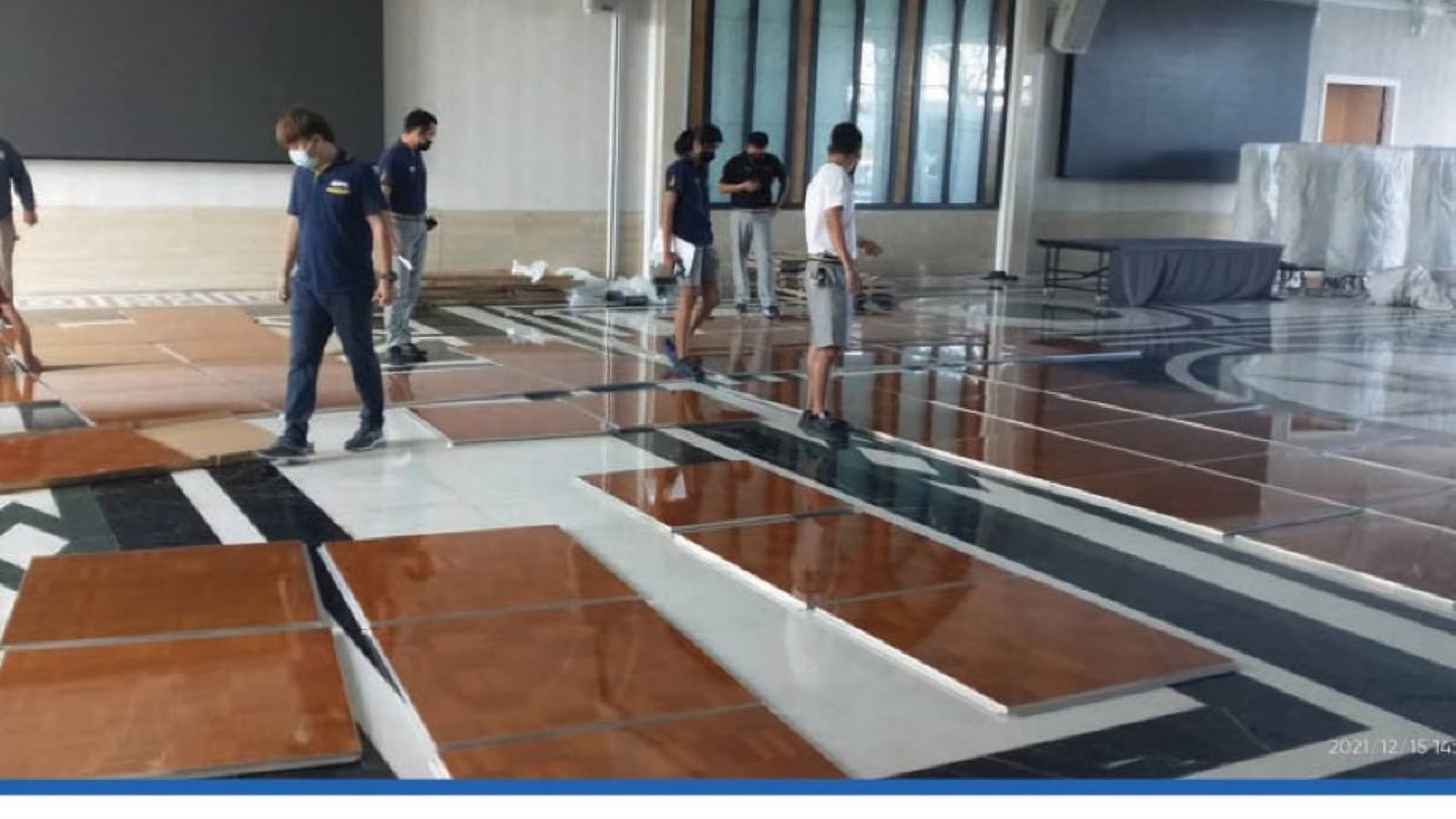 An installation team laying dance floor panels in a hotel function room