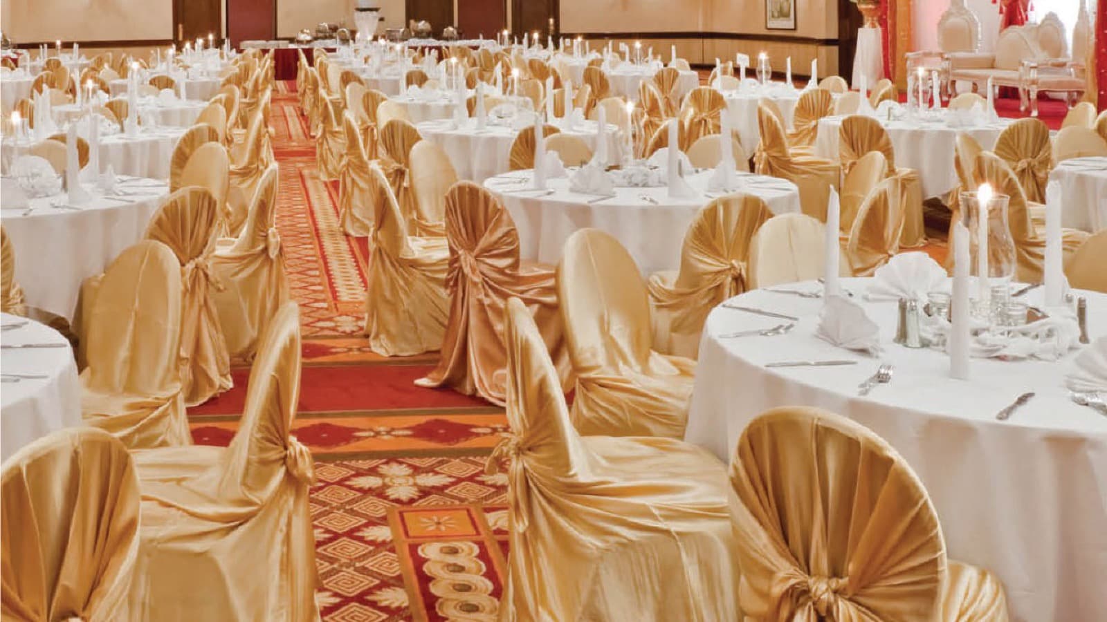 A hotel ballroom set for banquet service with satin-covered banquet chairs
